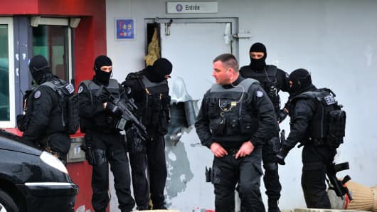 Members of Eris, a regional intervention unit  of the French penitentiary administration are at work in front of a door opened with explosives by an inmate, Redoine Faid, who managed to escape after holding five wardens hostage.